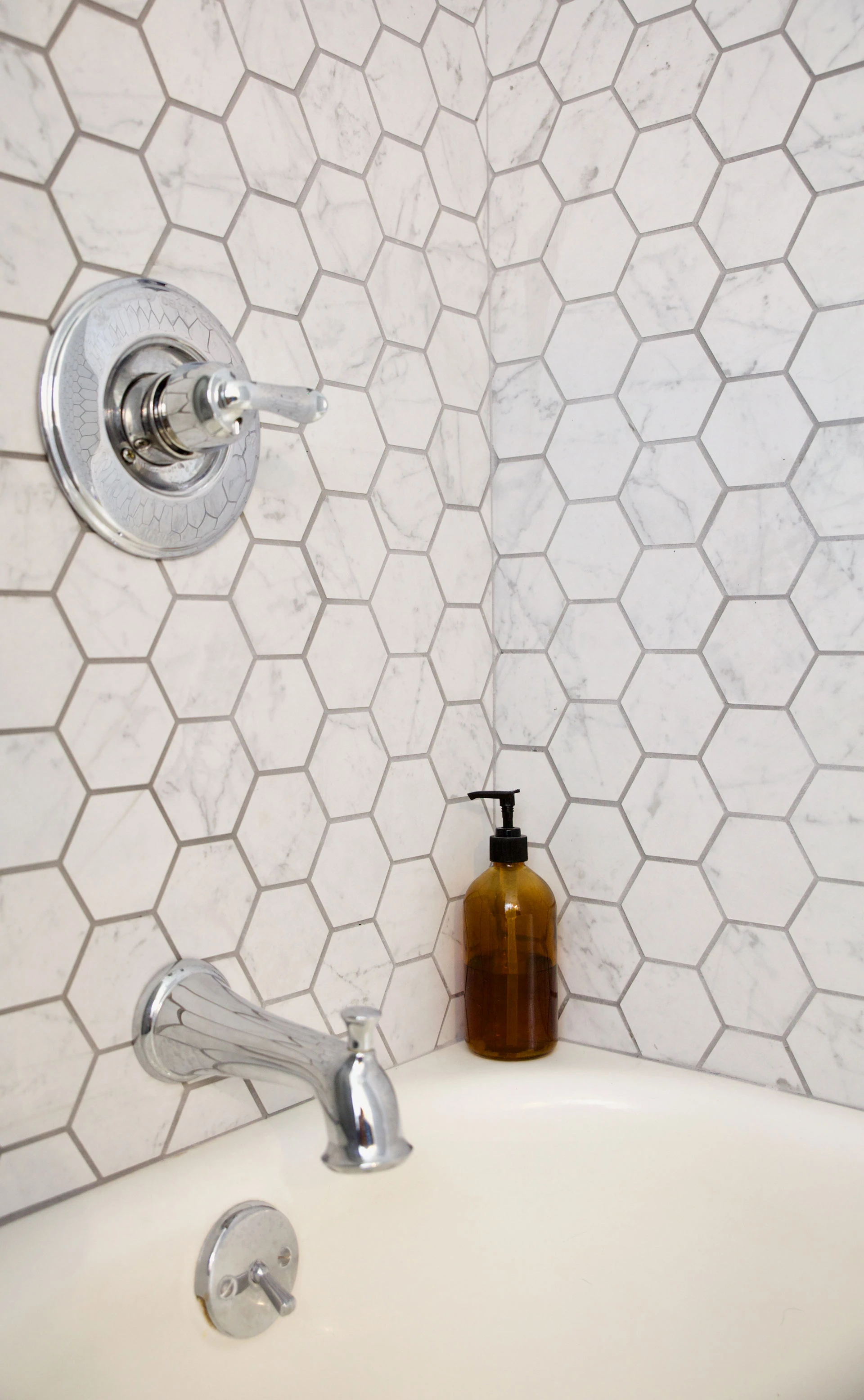 Atlas Concorde USA Eon Carrara Honeycomb Mosaic tile used as shower wall.